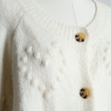 Cardigan en maille texturée avec un motif de coeurs